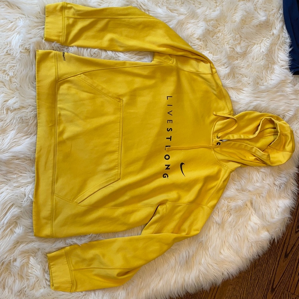 A yellow men’s Nike live strong hoodie